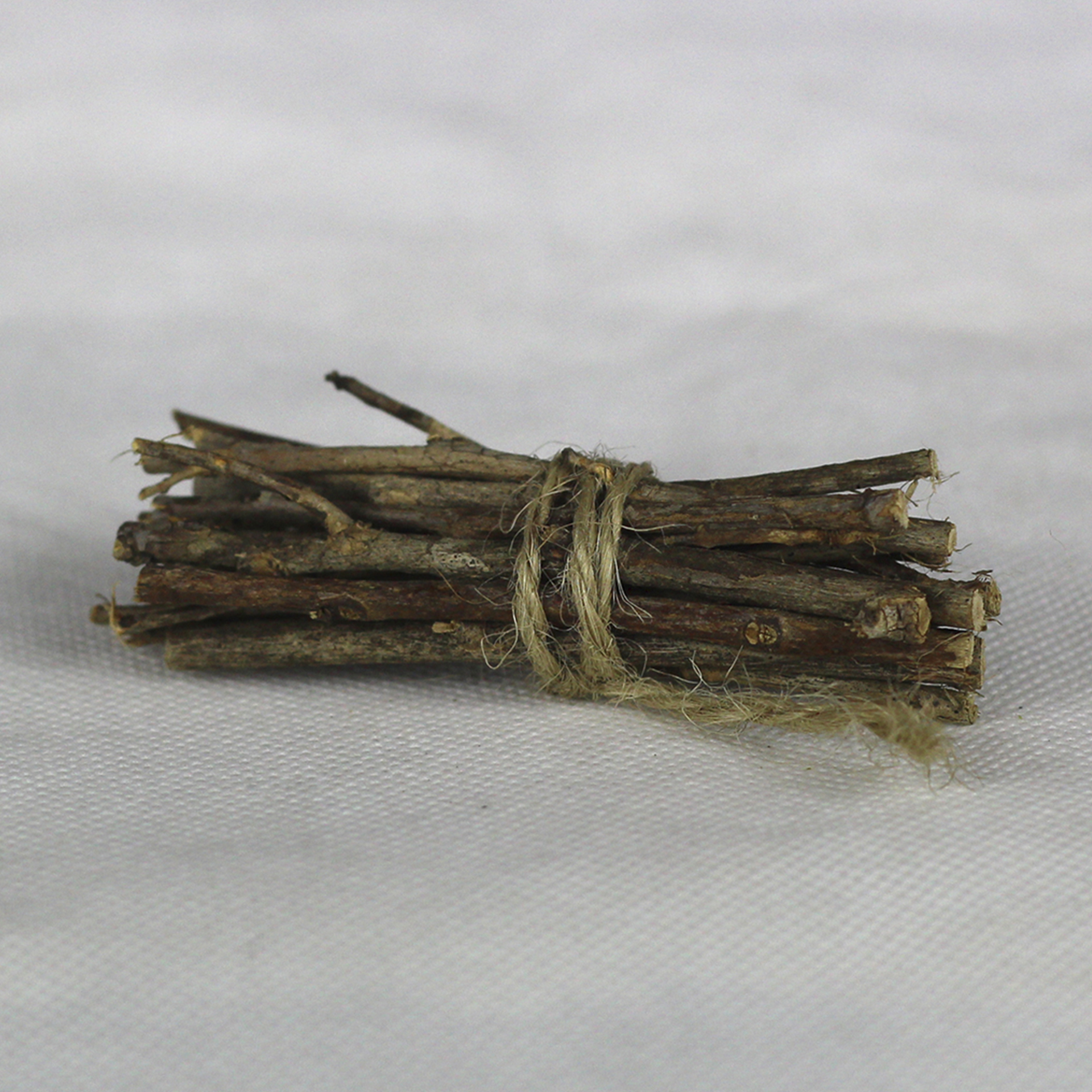 dünne Ästchen gebündelt, mit Kordel umwickelt